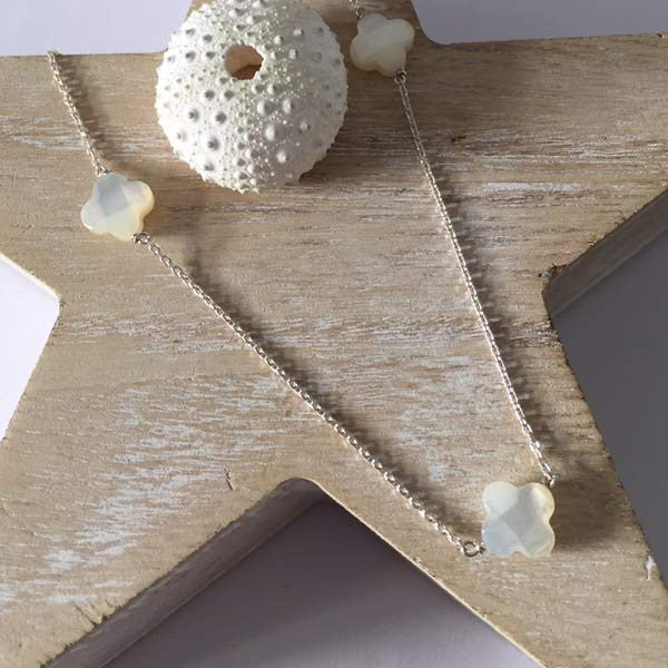 Silver chain necklace with 3 faceted white mother-of-pearl crosses