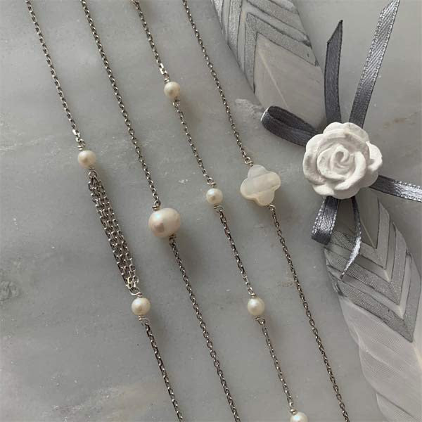 Triple silver chain bracelet with small white freshwater pearls