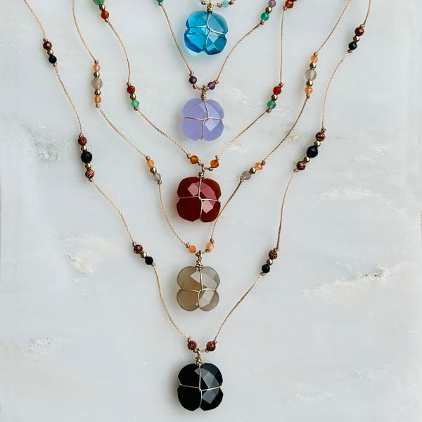 Gold plated chain necklace with oval faceted blue chalcedony