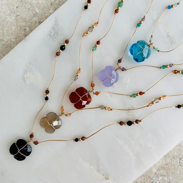 Gold plated chain necklace with oval faceted blue chalcedony