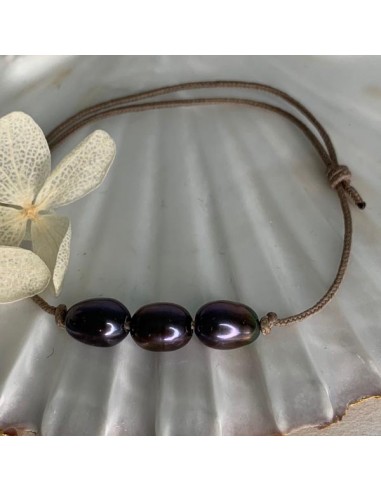 Three black freshwater pearls with...