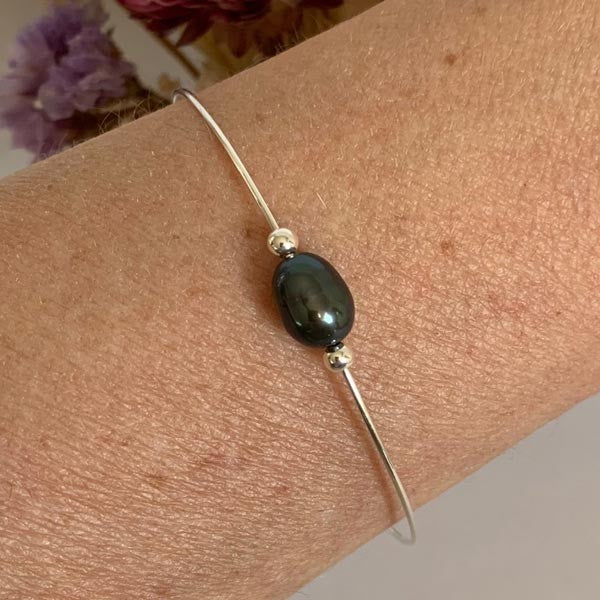 Fine silver bangle bracelet with black pearl beads