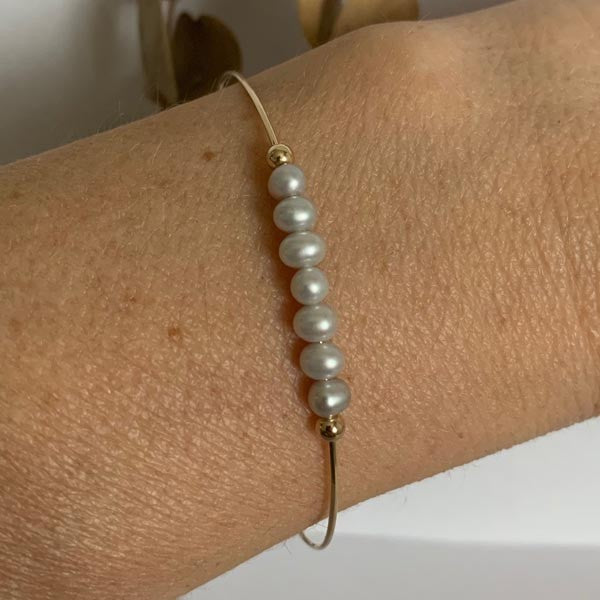 Fine gold filled bangle bracelet with 7 light grey beads