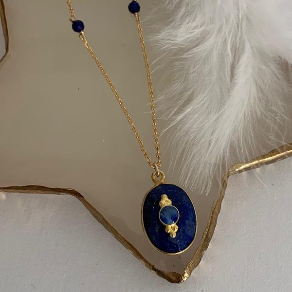 Gold plated chain necklace with faceted lapis lazuli set in an oval shape