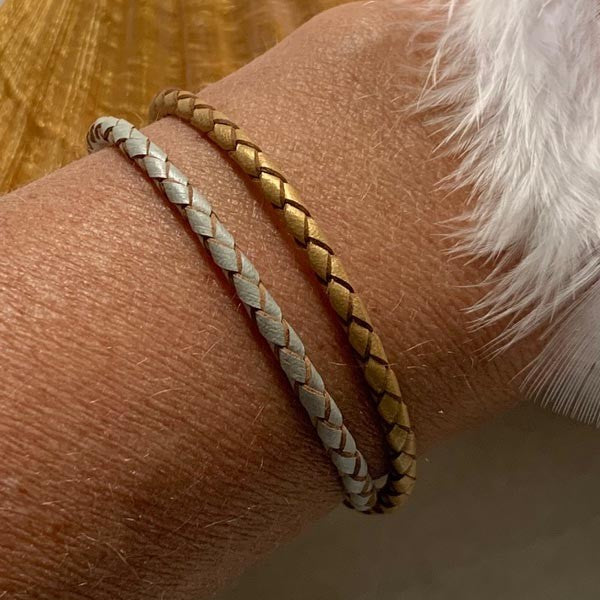 Duo of braided gold and silver leather bracelets