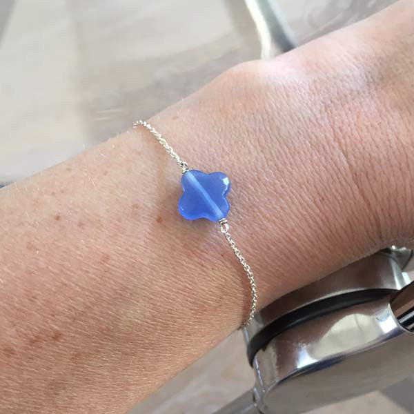 Silver chain bracelet with faceted blue cross