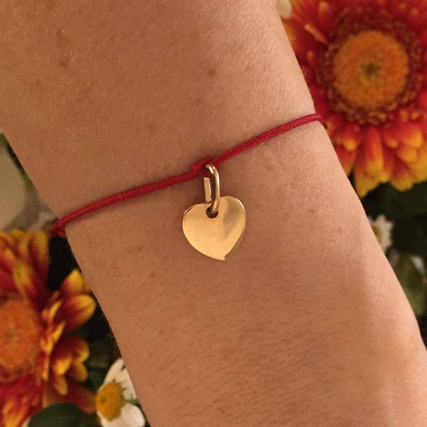 Cord bracelet with small gold-plated heart medal