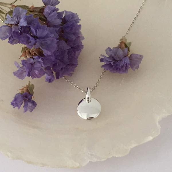 Silver chain necklace with small medal