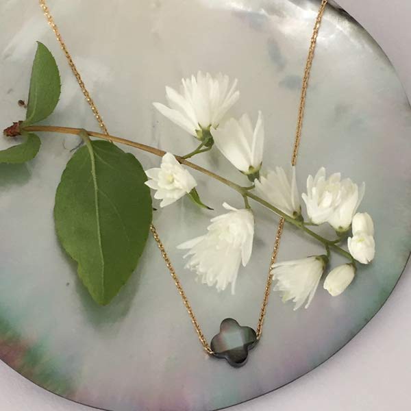 Gold plated chain necklace with small faceted gray mother-of-pearl cross 