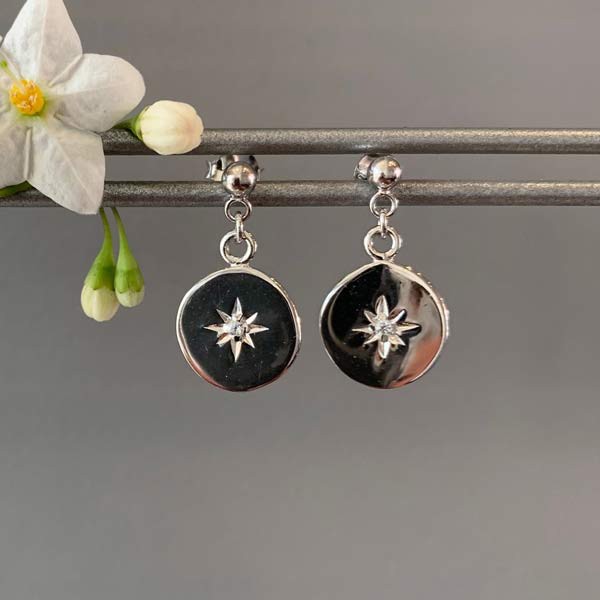 Silver earrings with star-shaped zircons