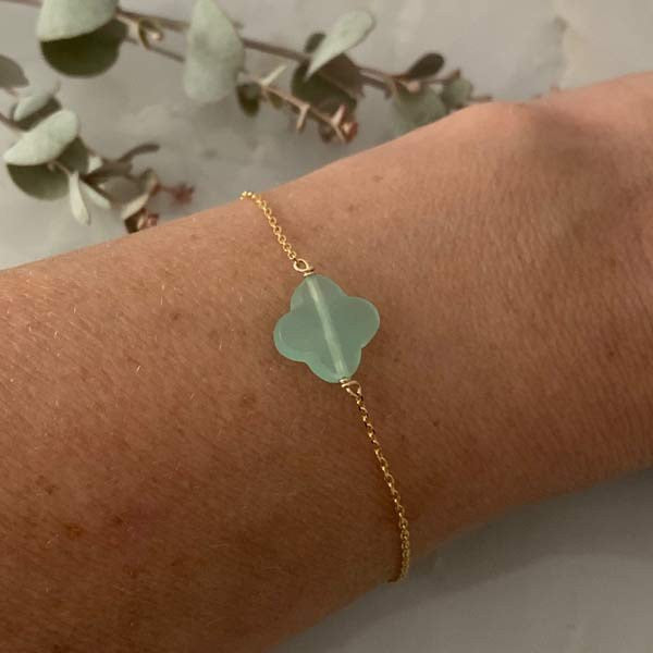 Gold plated chain bracelet with faceted cross in water green