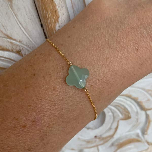 Gold plated chain bracelet with faceted cross in water green