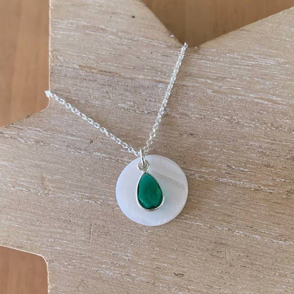 Silver chain necklace with white mother-of-pearl disc and green drop