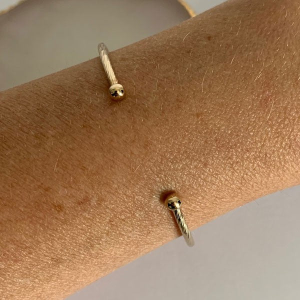 Fine gold-plated diamond-set bangle bracelet with 2 balls