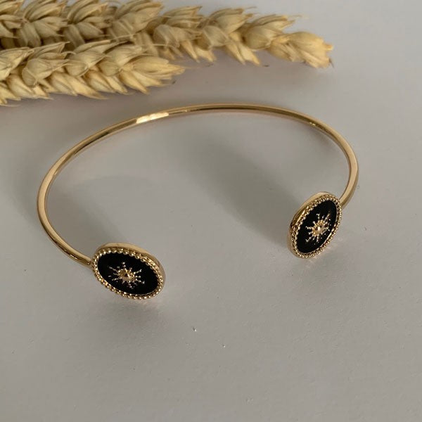 Fine gold-plated bangle bracelet with 2 black star beaded discs