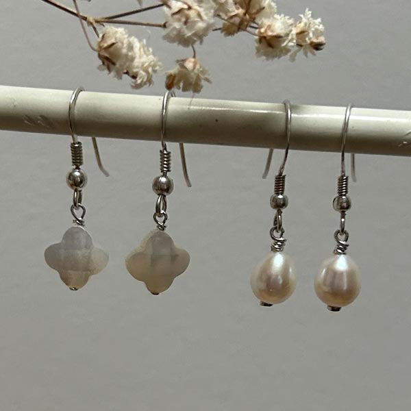 Silver earrings with white mother-of-pearl cross and faceted pompoms