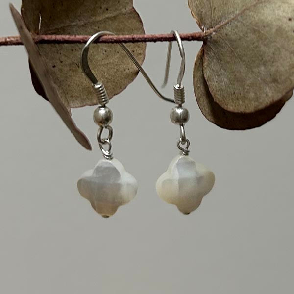 Silver earrings with white mother-of-pearl cross and faceted pompoms